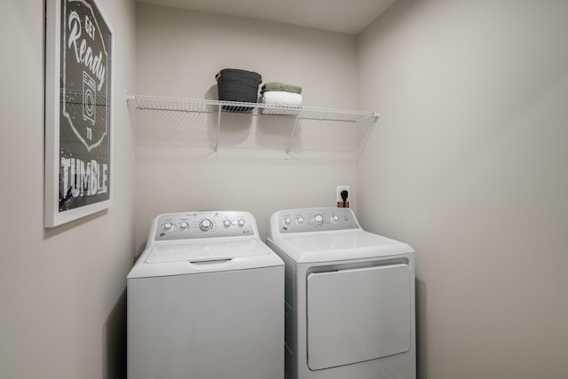 clothes washing area featuring laundry area and separate washer and dryer