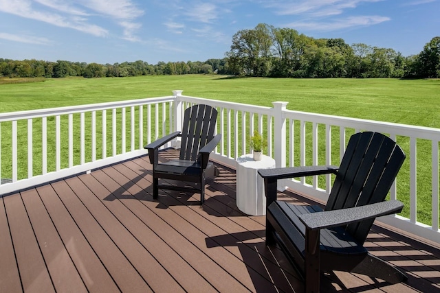 deck with a yard and a rural view