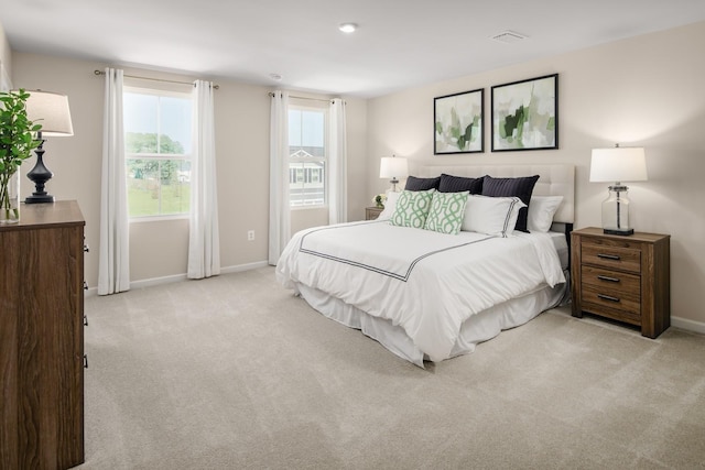 bedroom featuring light carpet and baseboards