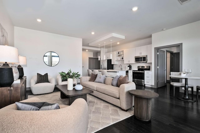 living area featuring wood finished floors and recessed lighting