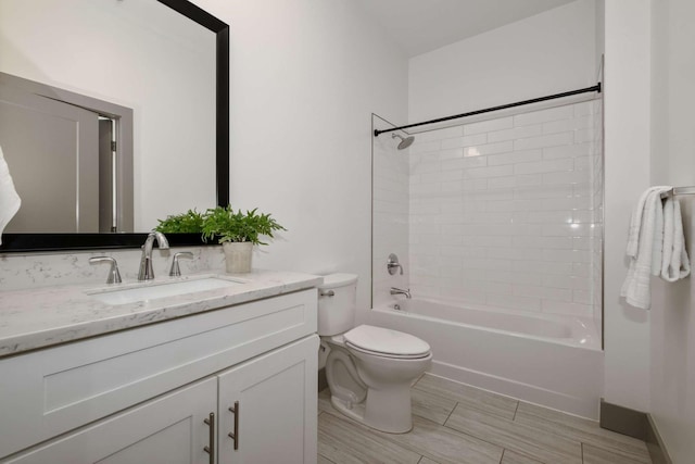 bathroom with toilet, shower / bathing tub combination, and vanity