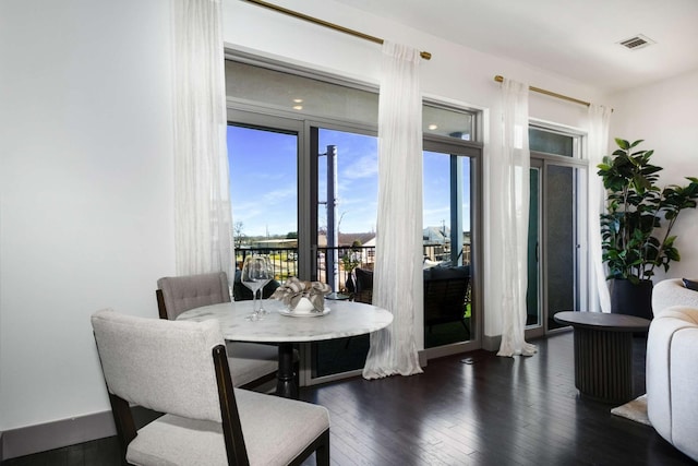 dining room with hardwood / wood-style floors and visible vents