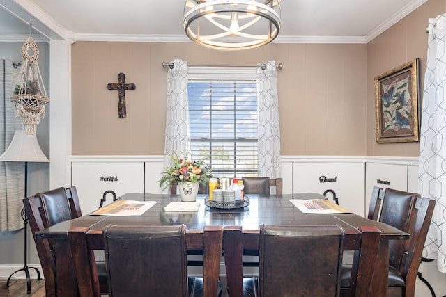 dining space featuring ornamental molding and a notable chandelier