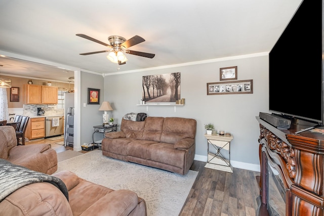 living area with crown molding, baseboards, and wood finished floors