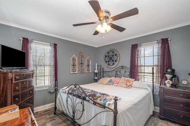 bedroom featuring ceiling fan, crown molding, baseboards, and wood finished floors