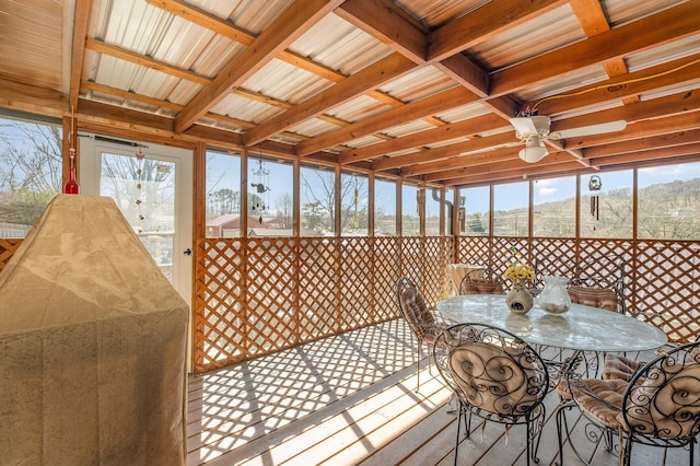 sunroom featuring ceiling fan