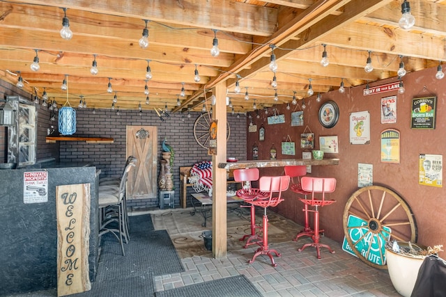 finished basement with a bar and brick floor