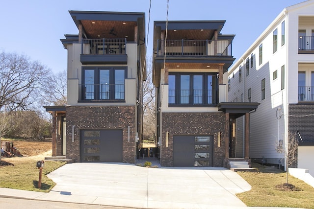 modern home with driveway, a ceiling fan, a balcony, an attached garage, and brick siding