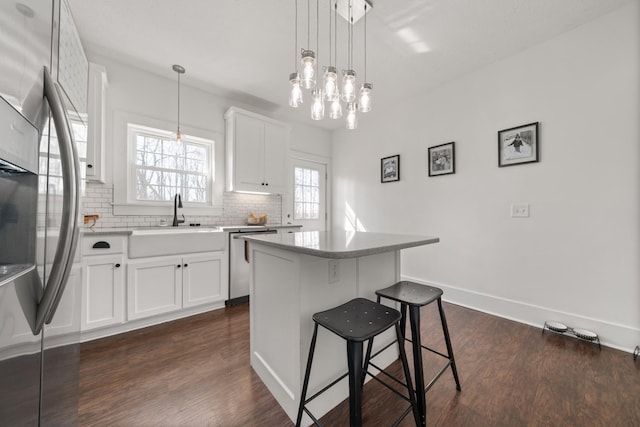 14437 Betts Rd, Goodlettsville, TN 37072 - kitchen with backsplash, dark wood finished floors, a breakfast bar area, stainless steel appliances, and a sink