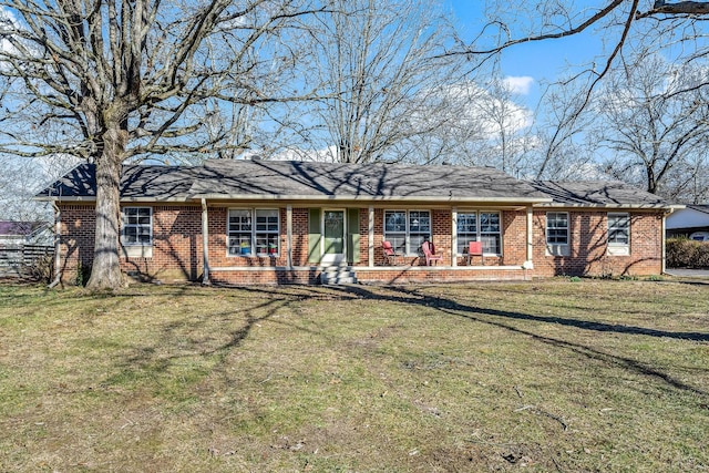 ranch-style house with a front lawn and brick siding