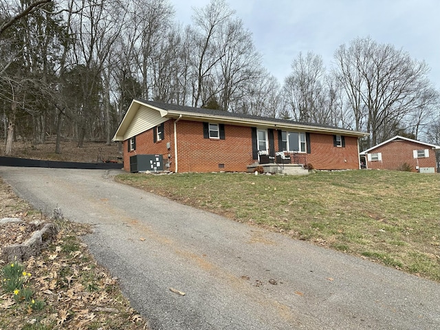 ranch-style home with driveway, brick siding, crawl space, and a front lawn