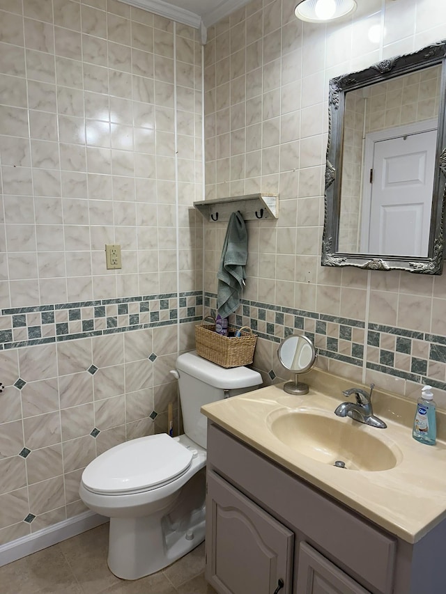 bathroom featuring decorative backsplash, toilet, tile patterned flooring, vanity, and tile walls