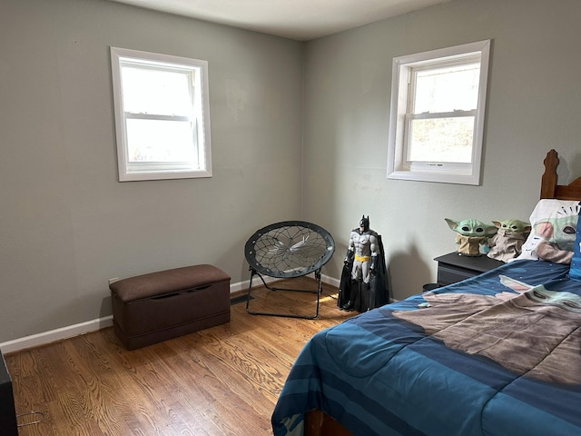 bedroom featuring baseboards and wood finished floors