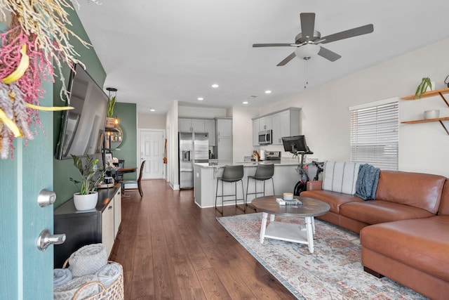 living room featuring dark wood-style floors, a ceiling fan, and recessed lighting