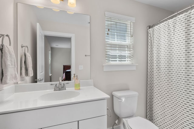 bathroom featuring toilet and vanity