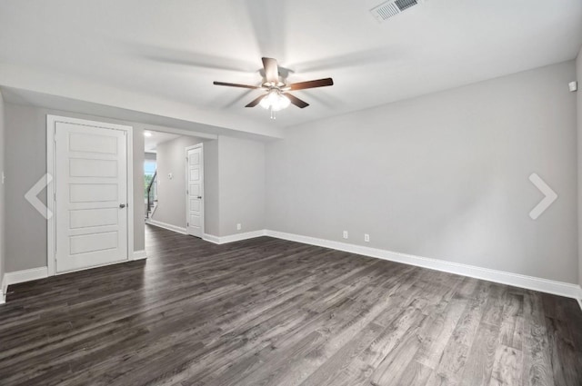 unfurnished room featuring visible vents, baseboards, dark wood-style flooring, and a ceiling fan