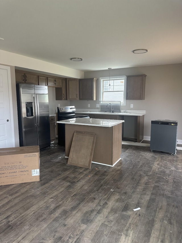 148 Cardinal Crk, Clarksville, TN 37040 - kitchen featuring stainless steel appliances, dark wood finished floors, a center island, light countertops, and dark brown cabinets