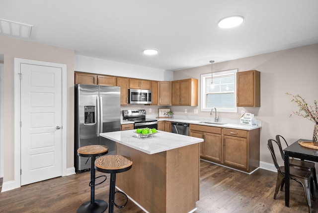 148 Cardinal Crk, Clarksville, TN 37040 - kitchen with stainless steel appliances, a sink, brown cabinets, and dark wood-style floors
