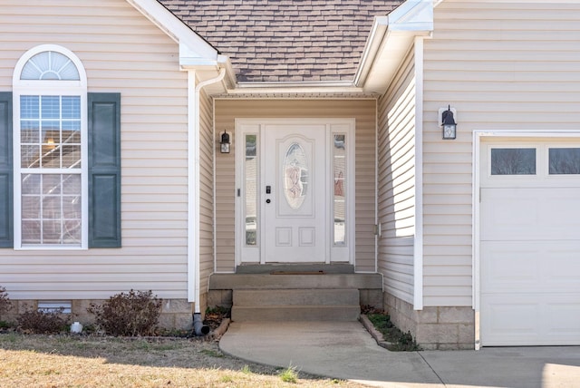 doorway to property featuring a garage and roof with shingles