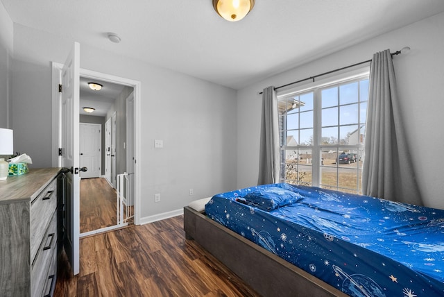 bedroom with baseboards and wood finished floors