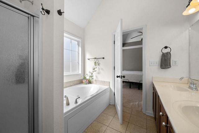 full bathroom featuring double vanity, a garden tub, tile patterned flooring, and a sink