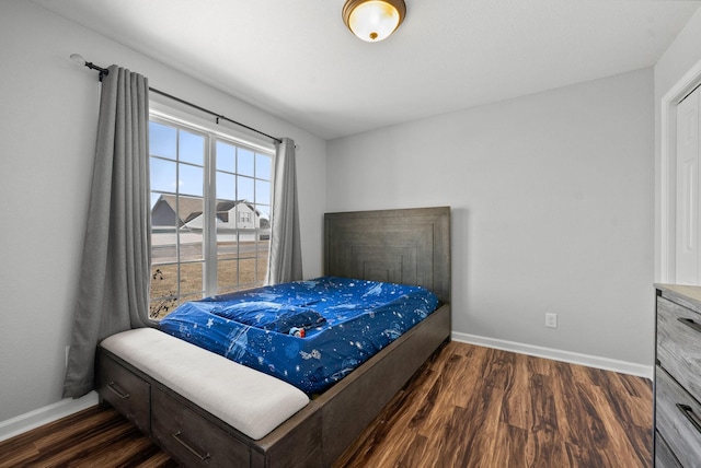 bedroom featuring wood finished floors and baseboards