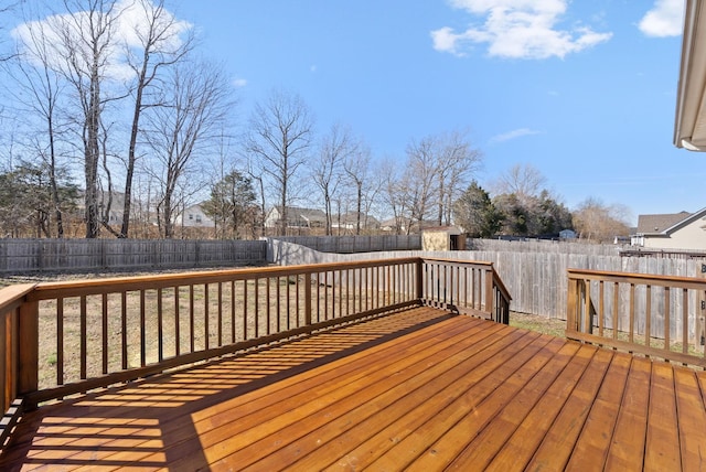 wooden deck with a fenced backyard