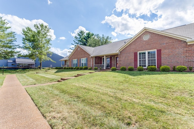 single story home featuring a front yard and brick siding