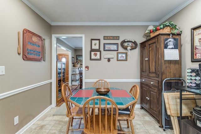 dining area featuring stone finish flooring, crown molding, and baseboards