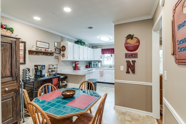 kitchen featuring visible vents, white cabinets, light countertops, crown molding, and recessed lighting