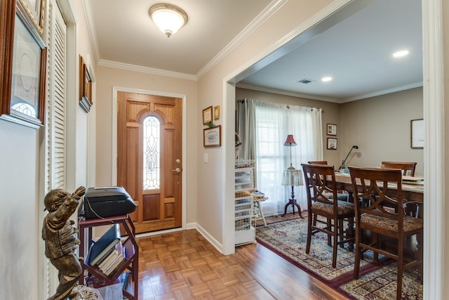 foyer with crown molding, visible vents, plenty of natural light, and baseboards