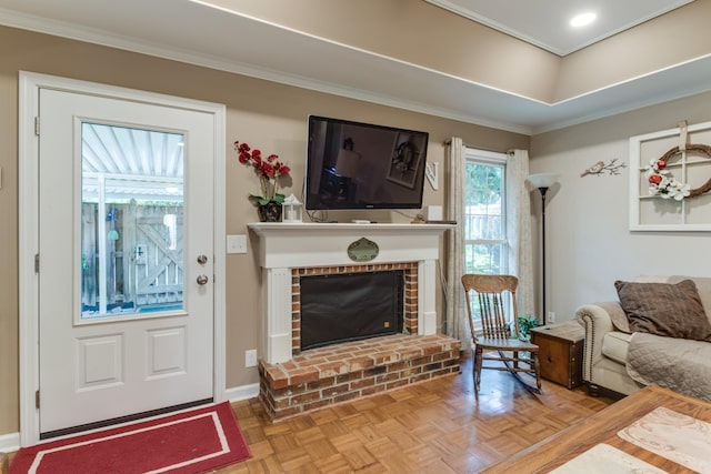 living room featuring a fireplace, baseboards, and ornamental molding