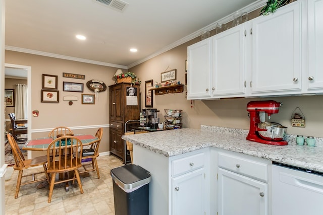 kitchen with crown molding, white cabinets, visible vents, and dishwasher