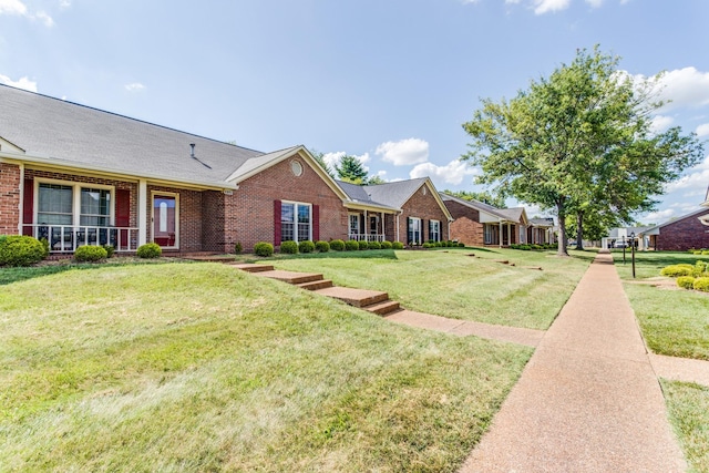 ranch-style house featuring brick siding and a front lawn