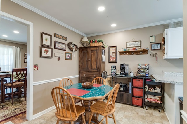 dining room featuring baseboards, ornamental molding, and recessed lighting