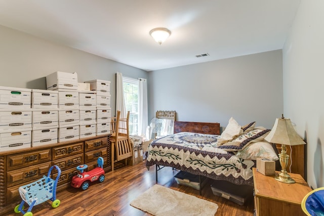 bedroom with visible vents and wood finished floors