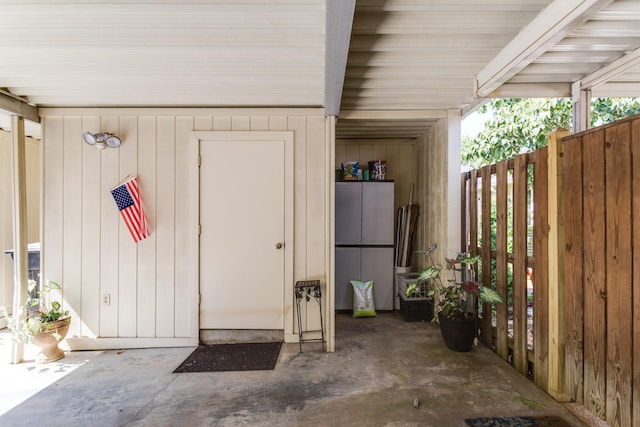 entrance to property featuring fence