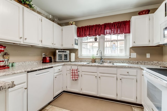 kitchen with light countertops, ornamental molding, white cabinets, a sink, and white appliances