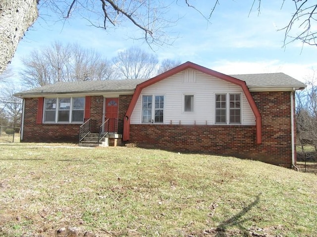 ranch-style house with a front yard and brick siding