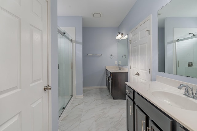 full bathroom with marble finish floor, a shower stall, visible vents, and a sink