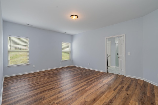 unfurnished room featuring dark wood finished floors and baseboards