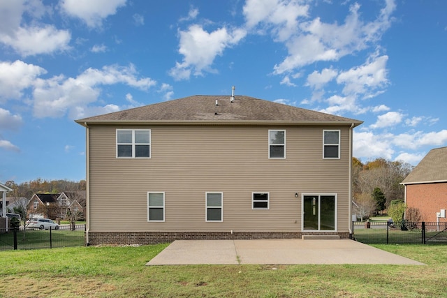 rear view of house with a patio, a yard, and fence