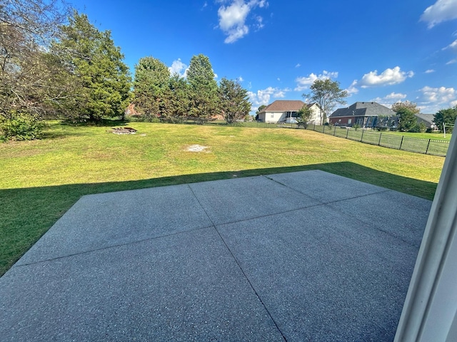 view of yard featuring a fire pit, a patio area, and fence