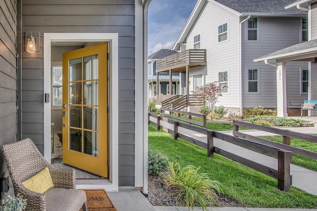 view of exterior entry featuring fence