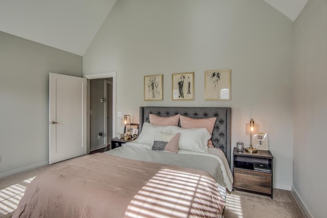 carpeted bedroom with high vaulted ceiling and baseboards