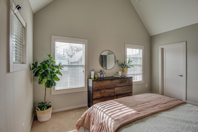 carpeted bedroom with high vaulted ceiling and baseboards