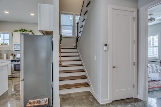 stairway featuring recessed lighting and baseboards