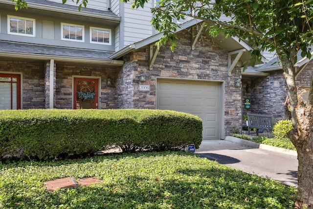 view of front of home with a shingled roof and an attached garage