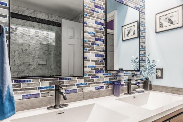 full bath featuring double vanity, tasteful backsplash, and a sink