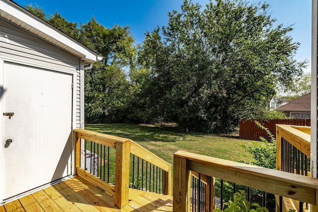 wooden terrace with fence and a lawn